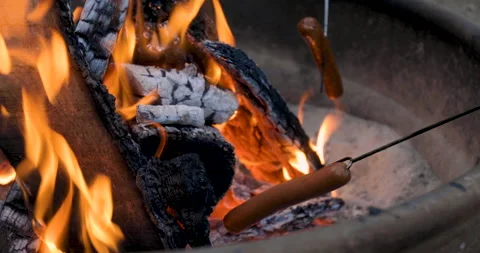Close Up Roasting Hot Dogs on Fire Stock Footage 165245936