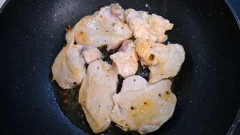Close-up of Roasting Poultry Fillets. Pieces of Chicken Meat in Frying Pan Stock Footage 146964064