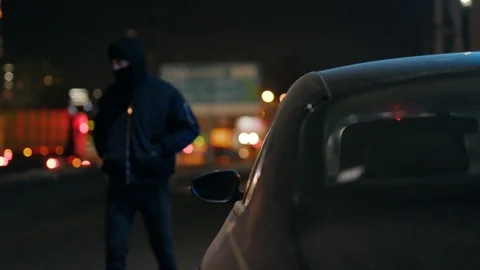 Close up robber man checking shines a flashlight in a car stealing at night Stock Footage 110888535