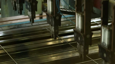 Close-up robot arms hoisting wire mesh Stock Footage 34262530