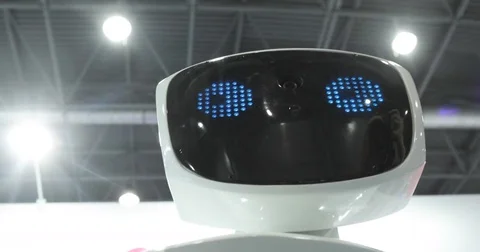 Close up of robot head. Robot emotions. The robot looks at the camera at the Stock Footage 76938706