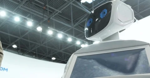 Close up of robot head. Robot emotions. The robot looks at the camera at the Видео 76938977