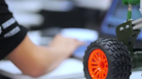 Close-up of robot wheels with orange rims Stock Footage 345398632