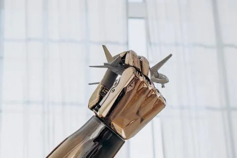 A close-up of a robotic bionic arm with metal spikes simulates the flight of an Stock Photos