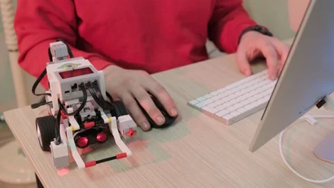 Close up of a robotics teacher hands, online course for his students using a Stock Footage 150905029