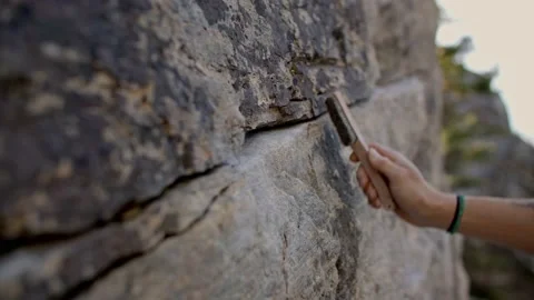 Close up of rock climber brushing off rock, boulder 库存影片 220306095
