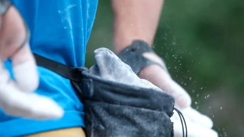 Close-up of a rock climber greasing his hands in a chalk bag. Stock Footage 147400919