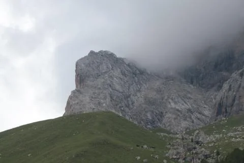 A close up of a rock mountain with clouds Stock Photos