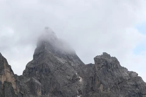 A close up of a rock mountain with clouds Stock Photos