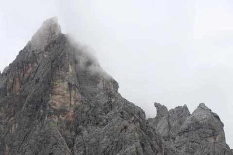 A close up of a rock mountain with clouds Stock Photos
