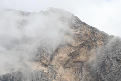 A close up of a rock mountain with clouds Stock Photos