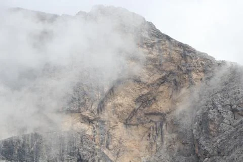 A close up of a rock mountain with clouds Stock Photos