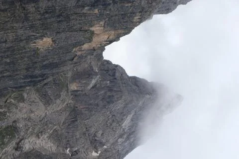 A close up of a rock mountain with clouds Stock Photos