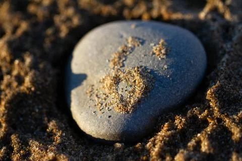 Close up of a rock on a sandy beach Stock Photos