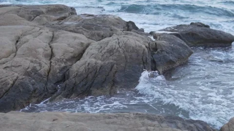 Close-up of a rock in the sea in the evening Stock Footage 254170879