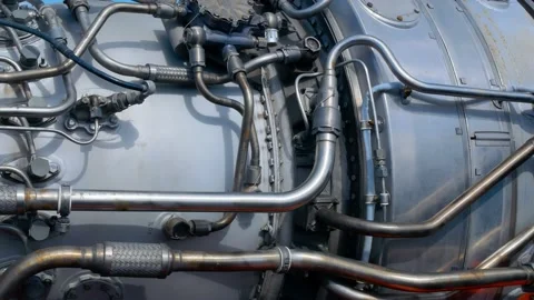 A close-up of a rocket engine with multiple pipelines supplying fuel and coolant Stock Footage 213243466