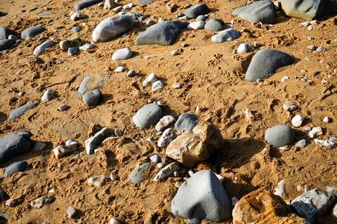 Close up of rocks on a sandy beach 写真素材