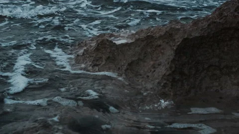 Close-up of rocks in the sea washed by small waves Stock Footage 159863624