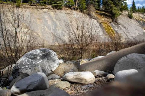 Close-Up of Rocks by Serene River Foto stock