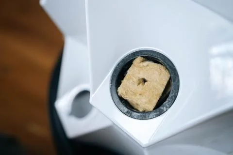 Close-up of rockwool cube placed inside vertical hydroponic tower, ready for Stock Photos