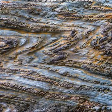 Close-up of a rocky structure showing zig-zag folded layers Stock Photos