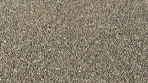 A close up of a rocky surface with many small rocks scattered across it Stock Photos