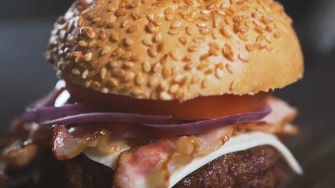 Close up: Roll for a burger falls on the cutlet, cheese and onions. Slow motion 스톡 동영상 111345223