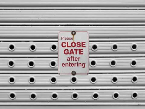 Close roll up gate sign Stock Photos