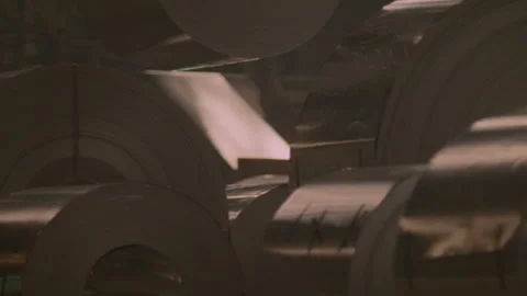 Close-up of a roll of steel being placed by a crane Stock Footage 312273230