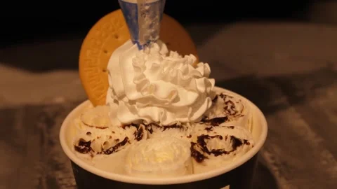 Close-up of Rolled Ice Cream with Whipped Cream and Biscuit Topping Stock Footage 345293230