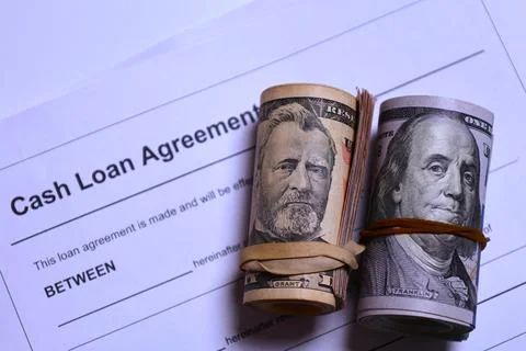 Close Up Rolled US Dollars On Loan Agreement Financial Debt Interest And Credit  库存照片