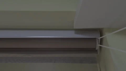Close Up of a Roller Blind Mechanism and Beaded Chain in a Window Recess Видео 345134423