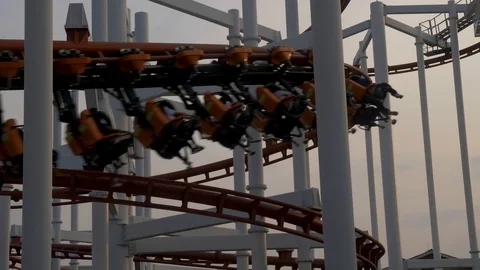 Close-up of a roller coaster train passing from left to right over the 스톡 동영상 101326398