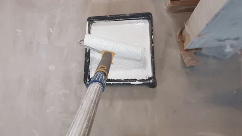 A close-up of the roller that paints the wall white. The roller travels along Stock Footage 207029801