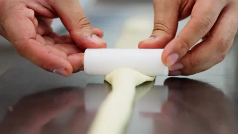 Close-up of rolling bread dough to make it flat, showcasing the hands-on process Stock Footage 276407028
