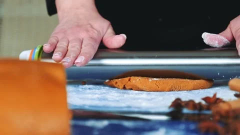 Close up of rolling dough with a rolling pin for making gingerbread cookies. Stock Footage 131539822