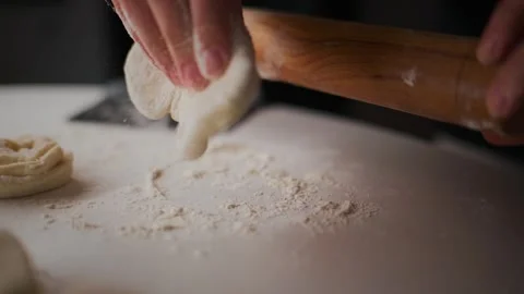 Close-up of rolling pin flattening dough 動画素材 336097798