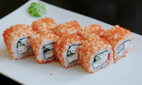 Close-up rolls with caviar with pickled ginger and wasabi on a white rectangular Foto stock