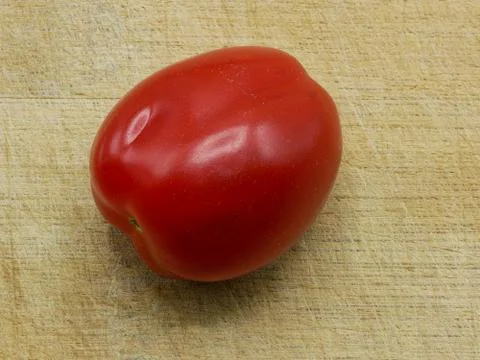 Close-up of A Roma Tomato Also Called Italian Tomato On A Cutting Board Stock Photos