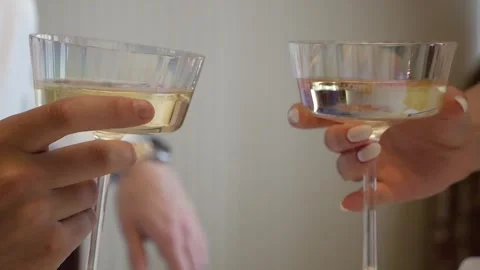 Close-up of a romantic couple clinking glasses of champagne on a date or wedding Stock Footage 334120389