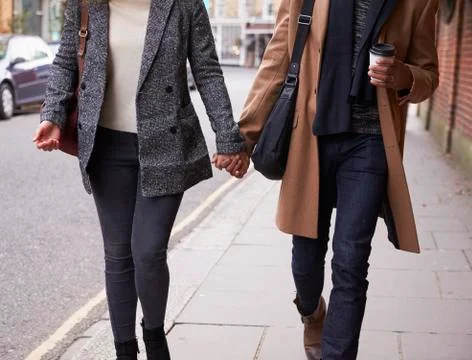Close Up Of Romantic Couple Walking On Fall Street In City Stock Photos