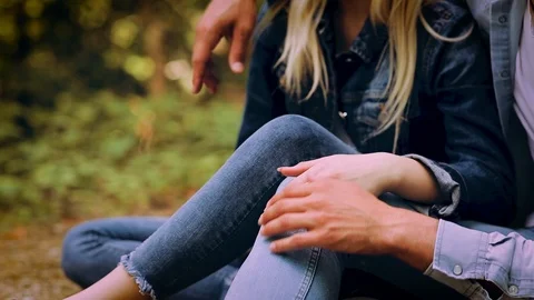 Close Up On Romantic Young Couple Sitting Together In Forest And Enjoying Video stock 89892850