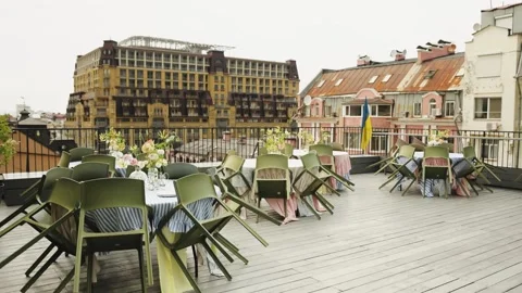 Close rooftop cafe with floral decor and stunning city views, ideal for events Stock Footage 318064697