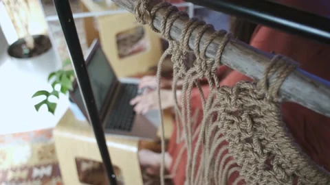 Close-up of a rope macrame on the background of a woman with a laptop Stock Footage 237708416