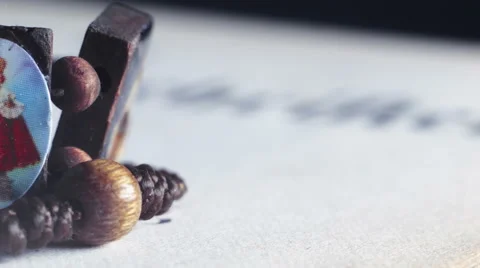 Close up of a rosary on an opened bible Stock Footage 55369735