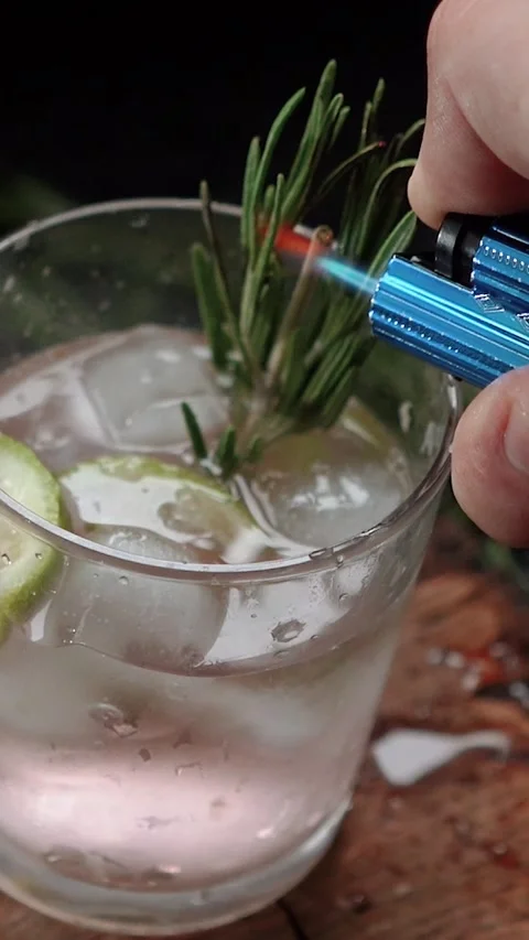 Close-up of rosemary being set on fire. The process of preparing a cocktail and Stock Footage 279915516