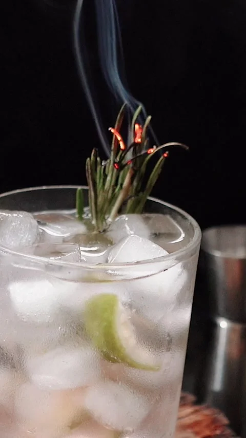 Close-up of rosemary being set on fire. The process of preparing a cocktail and Stock Footage 279915641