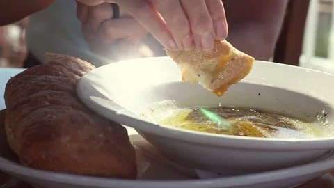 Close up of rosemary bread dipped in olive oil with pesto in winery Stock Footage 77285048
