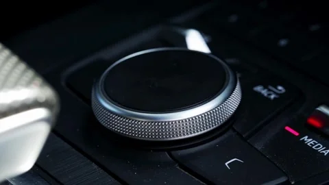 Close-up of rotary control knob on car interior media system dashboard, modern Stockbeeldmateriaal 342230169