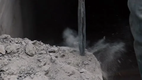 Close-up. Rotary Hammer breaks a wall of concrete. Slow motion. Pieces of Video stock 133295197